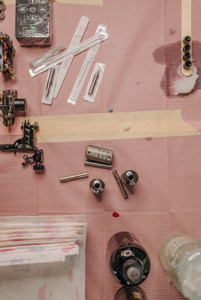 social-feed-img-02 Flat lay of tattoo equipment arranged on a worktable for precise artistry.