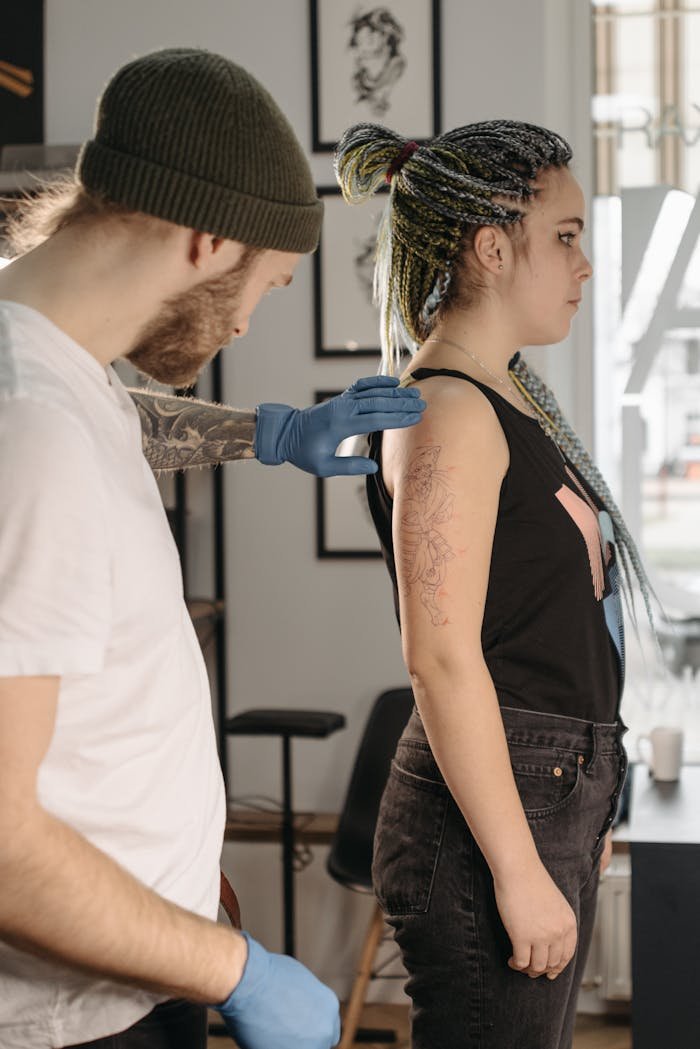 private-party-02 Tattoo artist working on a woman in a studio setting, preparing to ink new design.